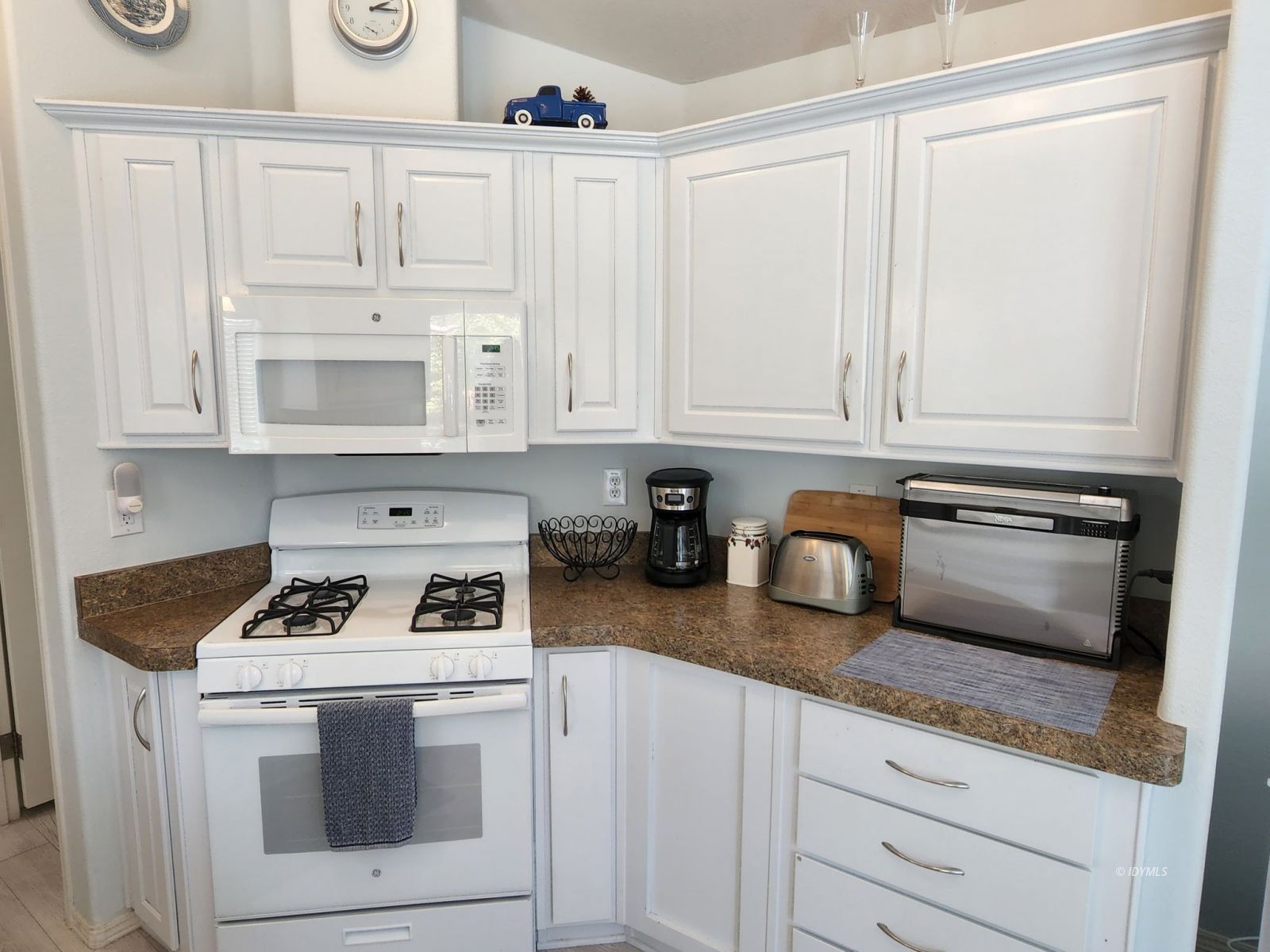 25955 Highway 243, Unit 45 Idyllwild, CA 92549 - Photo 9 of 25 a kitchen with granite countertop white cabinets and white appliances