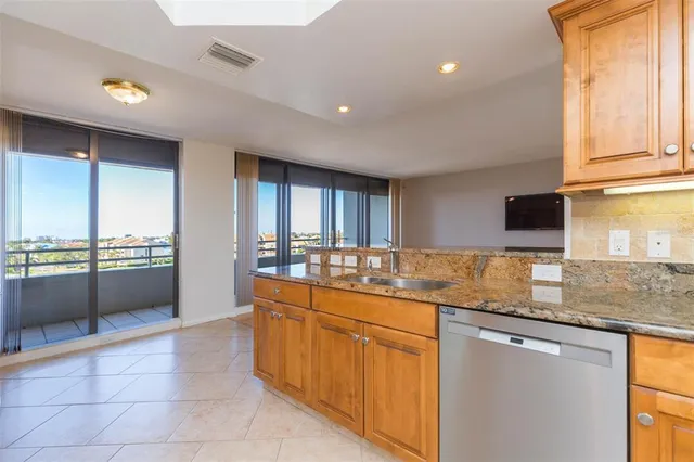 a kitchen with stainless steel appliances granite countertop a sink and a stove