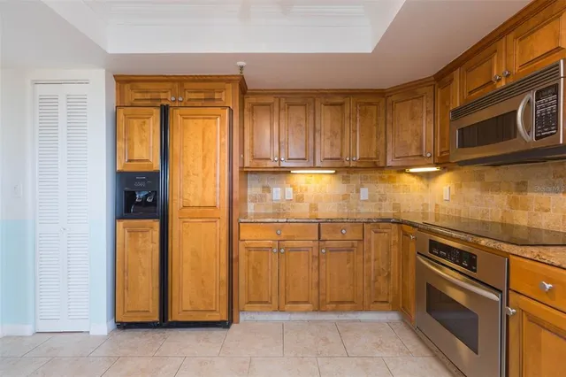 a kitchen with a refrigerator stove and cabinets