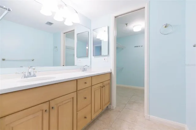 a spacious bathroom with a granite countertop sink a mirror and a shower