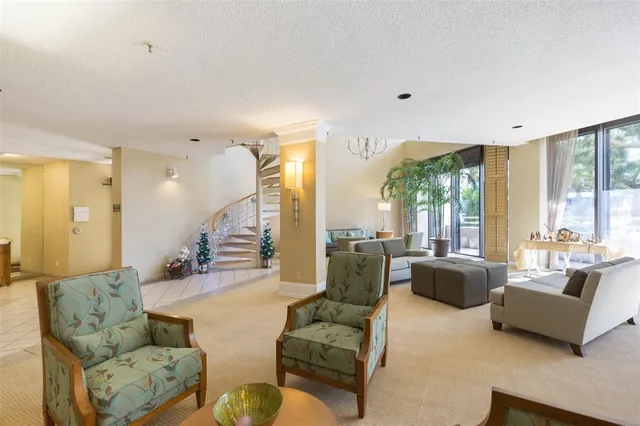 a living room with furniture and large windows