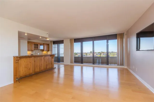 a view of a living room a kitchen with a large window