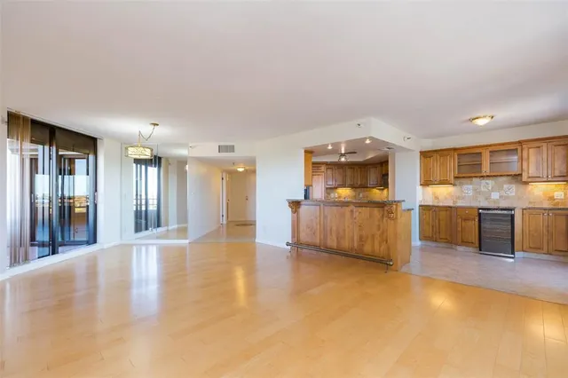 a view of a kitchen with a sink and a refrigerator