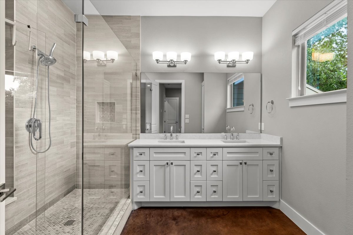913 Stobaugh Street, Unit B Austin, TX 78757 - Photo 25 of 40 Double vanity and a spacious glass-enclosed shower create a practical bathroom retreat.