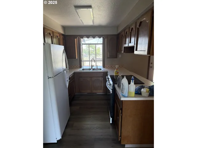 a view of a hallway with furniture and a window