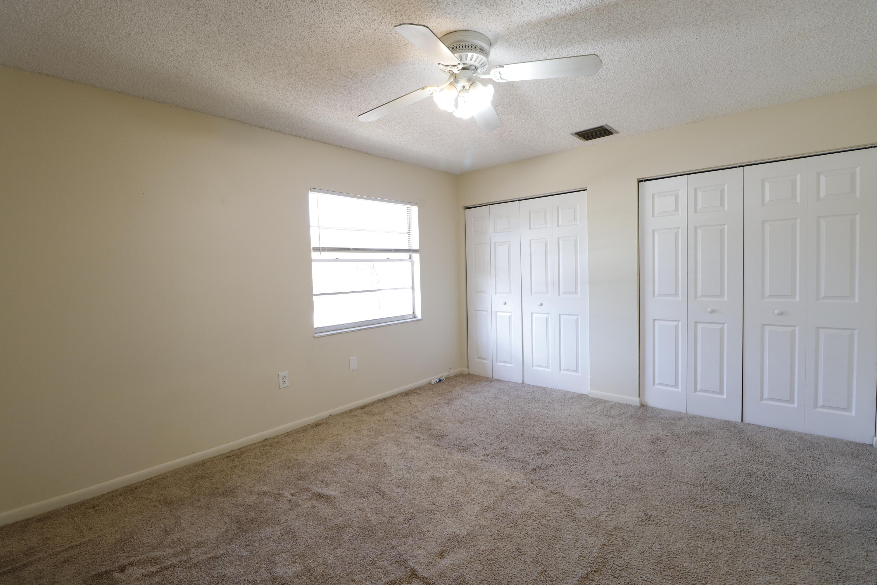 2016 South 10th Street, Unit A Fort Pierce, FL 34950 - Photo 12 of 13 an empty room with windows and fan
