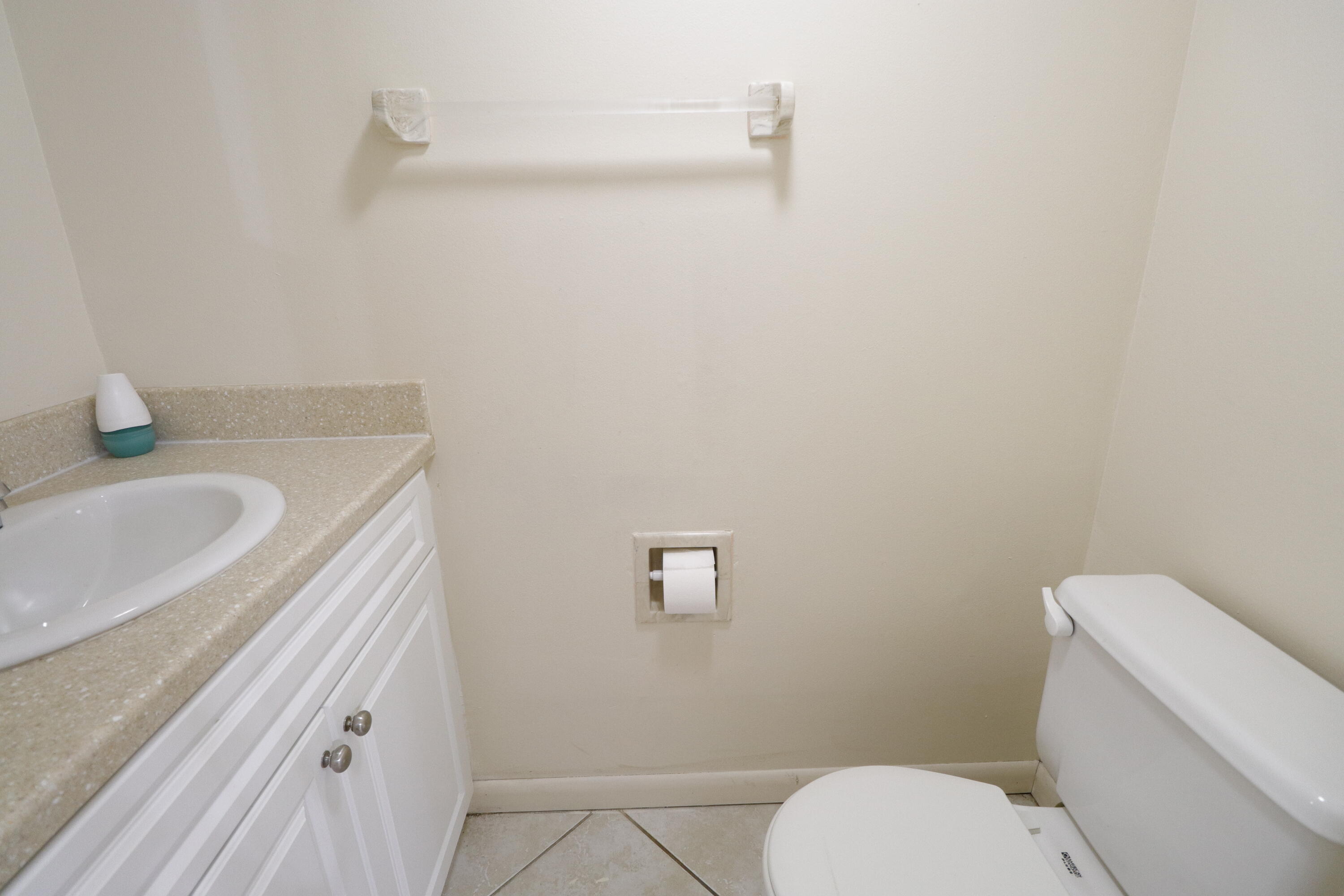 2016 South 10th Street, Unit A Fort Pierce, FL 34950 - Photo 6 of 13 a bathroom with a granite countertop toilet and a sink