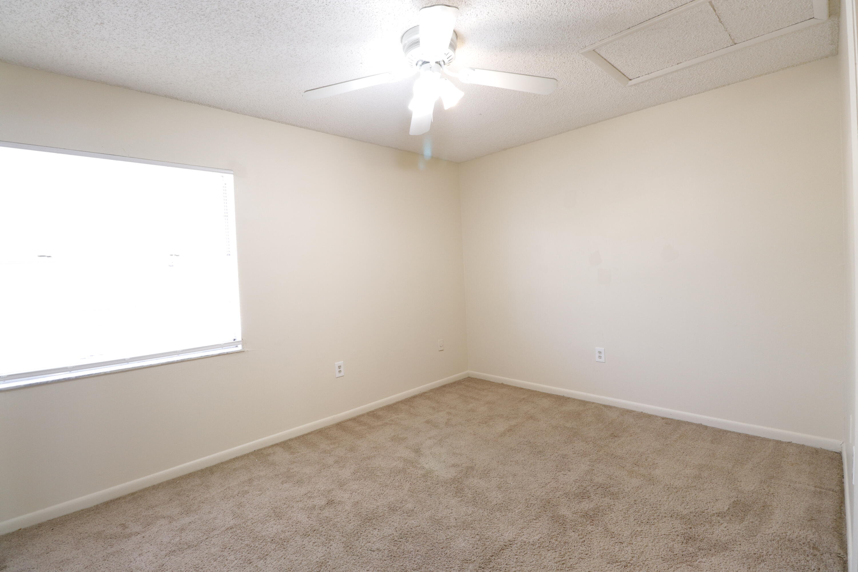 2016 South 10th Street, Unit A Fort Pierce, FL 34950 - Photo 8 of 13 an empty room with a window and a fan