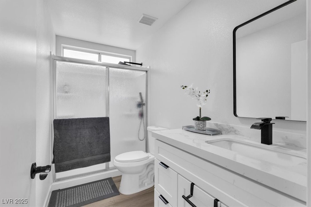1219 Heather Ridge Road North Las Vegas, NV 89031 - Photo 18 of 32 Full bath featuring vanity, a shower stall, and wo