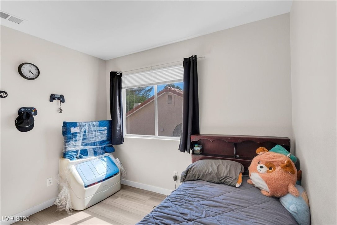 1219 Heather Ridge Road North Las Vegas, NV 89031 - Photo 23 of 32 Bedroom with baseboards and wood finished floors