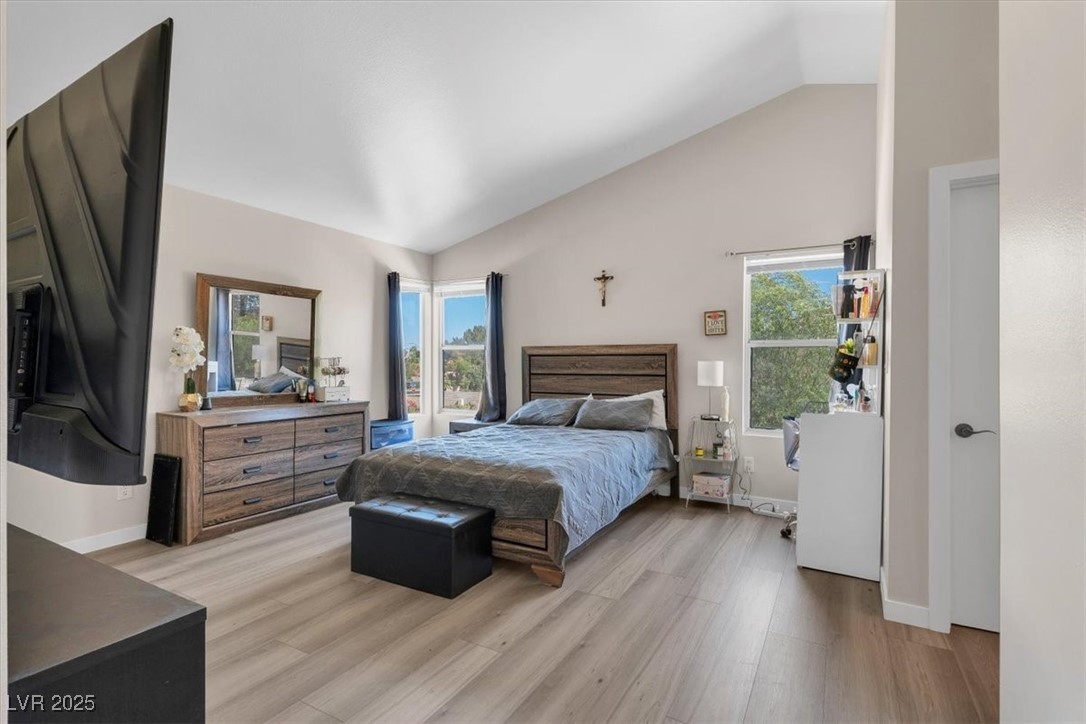 1219 Heather Ridge Road North Las Vegas, NV 89031 - Photo 27 of 32 Bedroom with lofted ceiling, light wood finished f