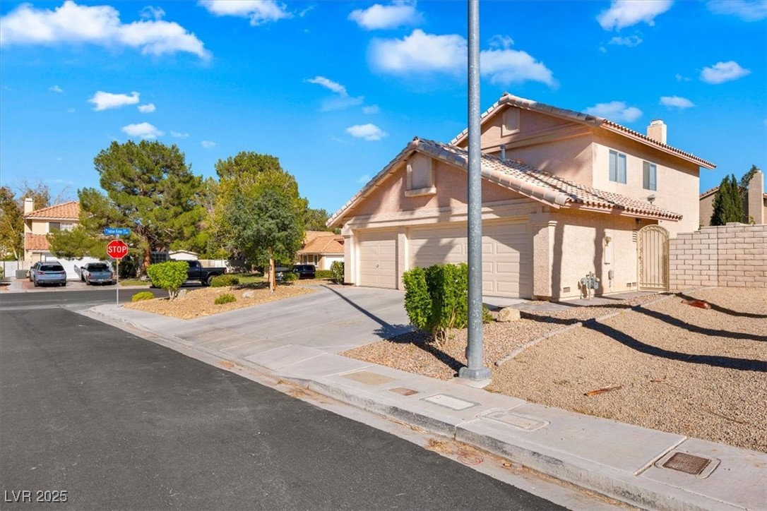 1219 Heather Ridge Road North Las Vegas, NV 89031 - Photo 3 of 32 View of front of home featuring stucco siding, a c