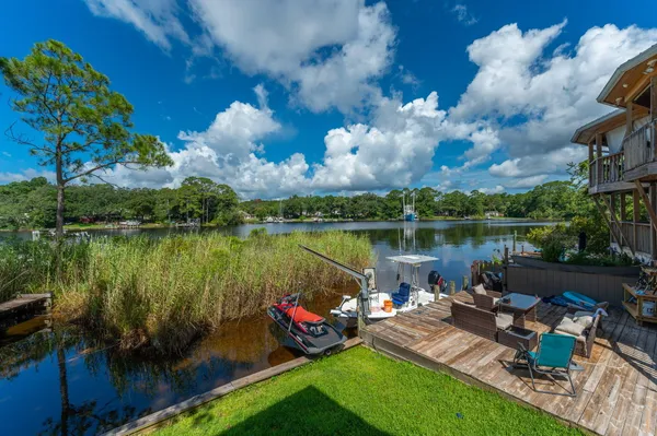 a view of a lake with lawn chairs