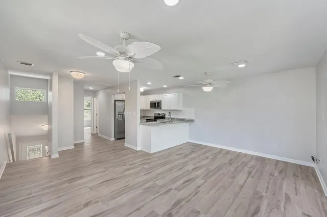 a view of kitchen with granite countertop cabinets and refrigerator