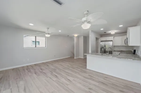 a view of kitchen with sink and wooden floor