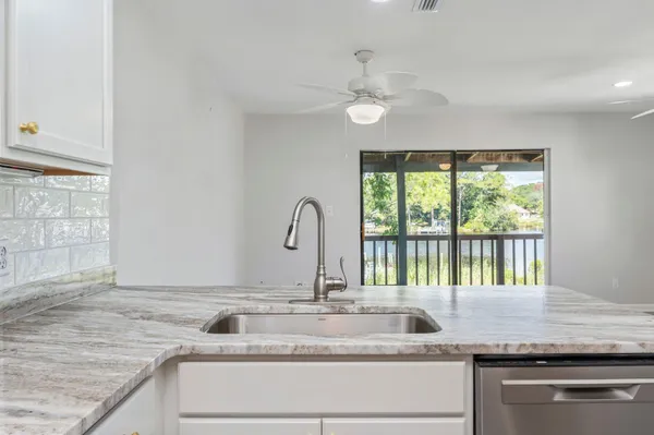 a kitchen with granite countertop a sink and a window