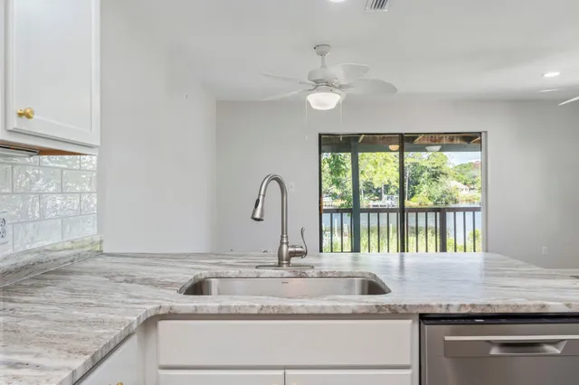 a kitchen with granite countertop a sink and a window
