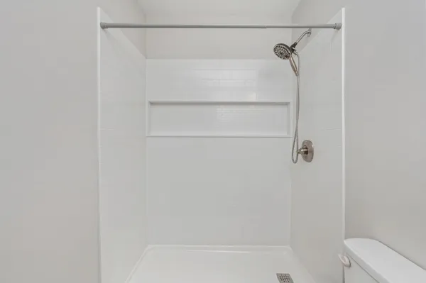 a bathroom with a shower and a bath tub