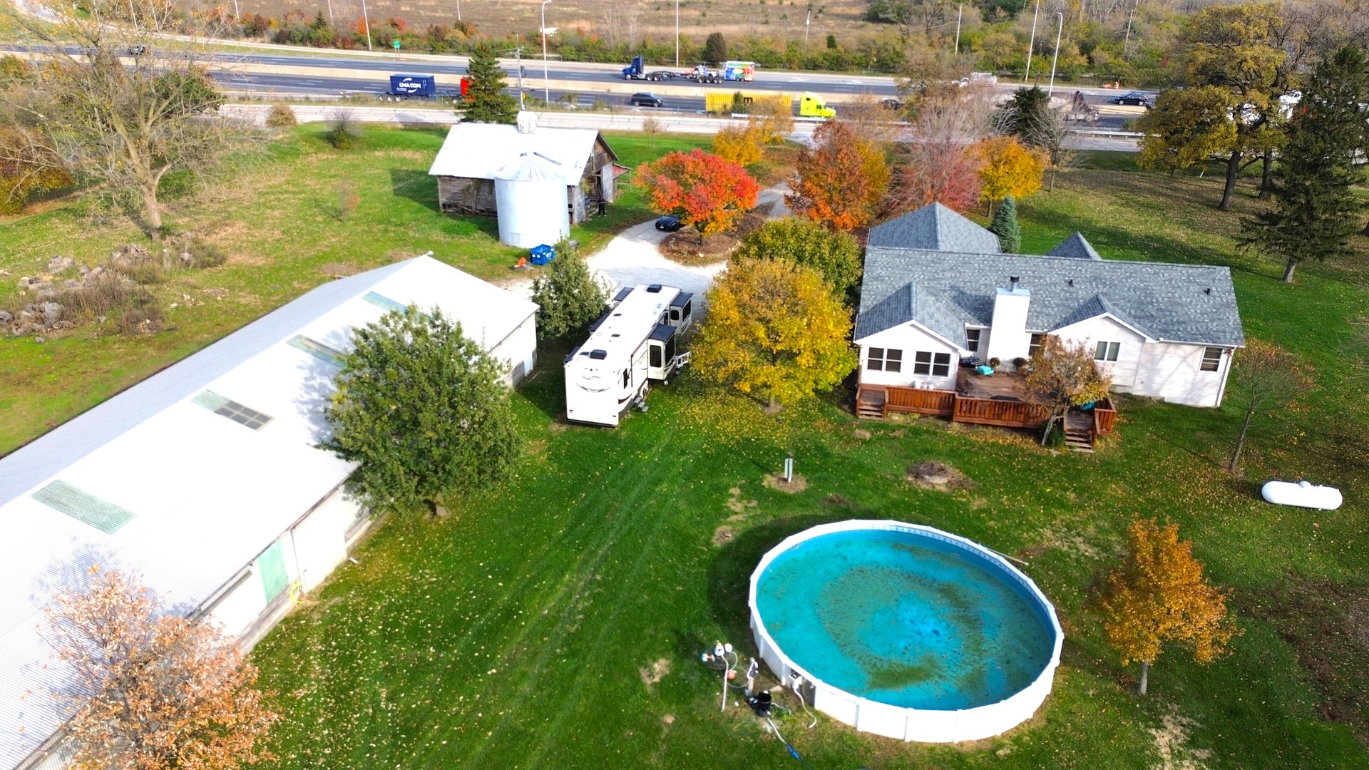 22116 Southwest Frontage Road Shorewood, IL 60404 - Photo 34 of 35 a aerial view of a house with a swimming pool and lake view