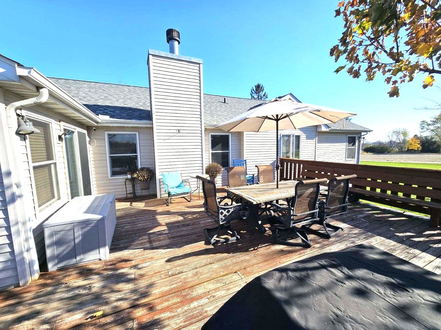 22116 Southwest Frontage Road Shorewood, IL 60404 - Photo 8 of 35 a view of a patio with table and chairs under an umbrella with wooden floor