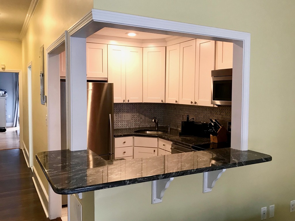 241 Beacon Street, Unit 3 Boston, MA 02116 - Photo 5 of 17 a kitchen with a sink a counter top space and cabinets
