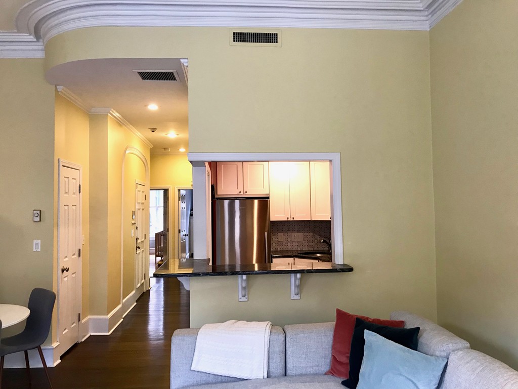 241 Beacon Street, Unit 3 Boston, MA 02116 - Photo 7 of 17 a living room with a couch and a flat screen tv