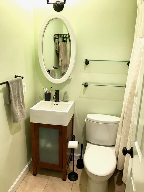 241 Beacon Street, Unit 3 Boston, MA 02116 - Photo 9 of 17 a bathroom with a toilet sink and mirror
