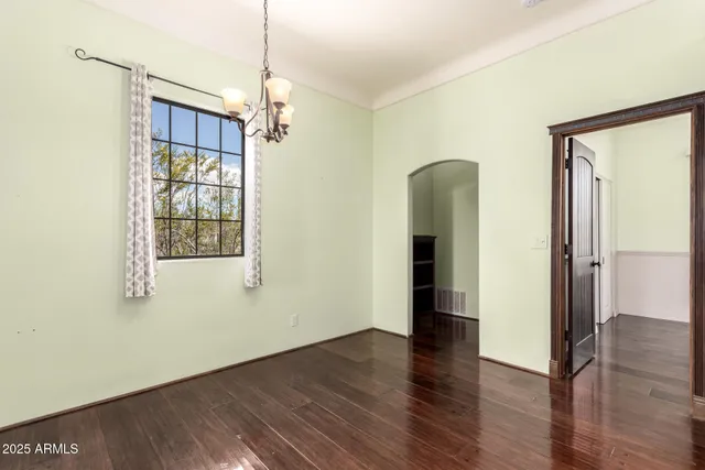 a view of a room with wooden floor and windows