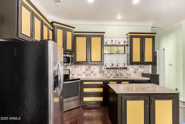 a kitchen with a refrigerator and a sink