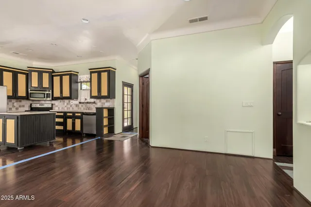 a view of a kitchen with furniture and wooden floor