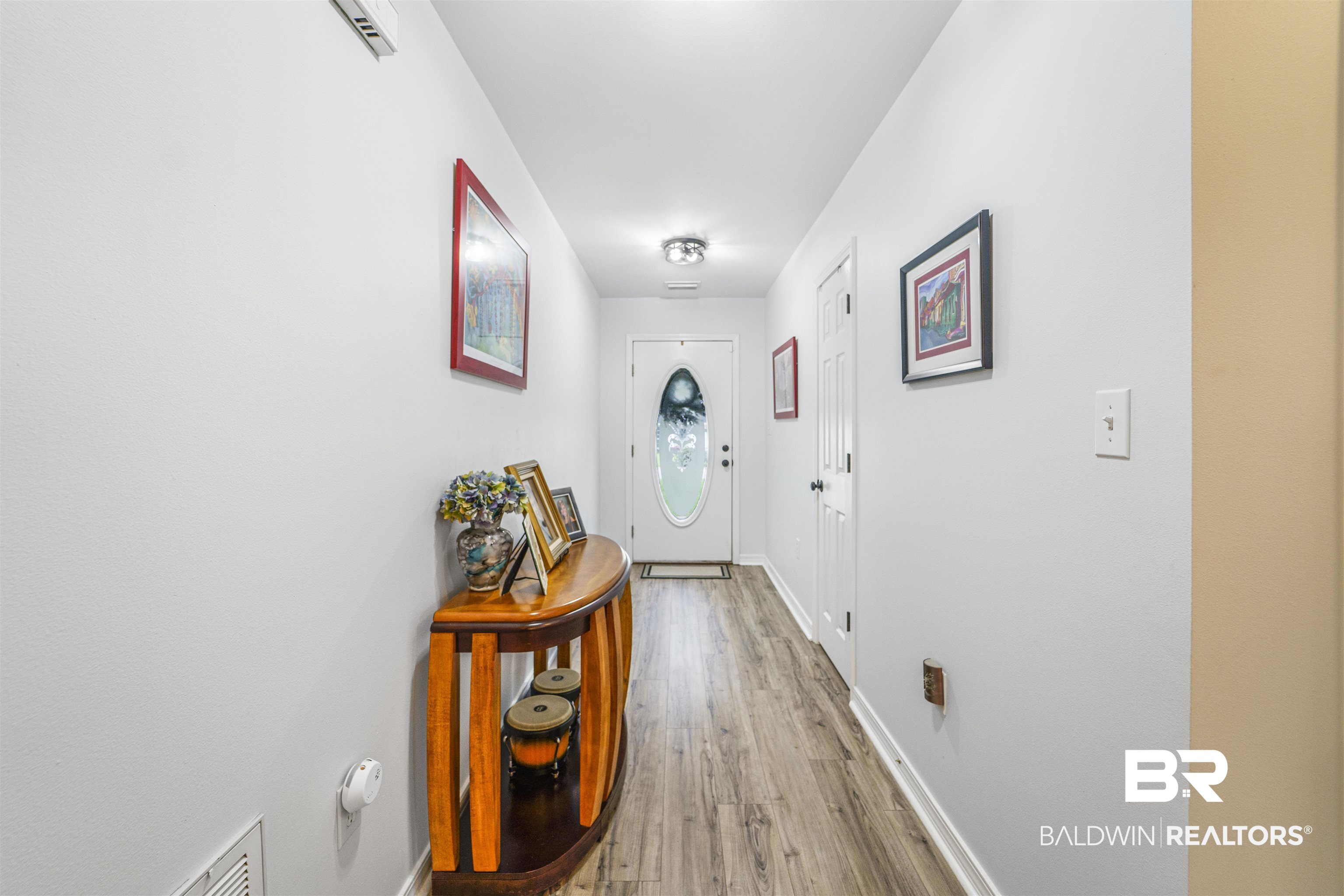 4620 Pine Boulevard Orange Beach, AL 36561 - Photo 19 of 49 Doorway to outside featuring light wood-style floors and baseboards