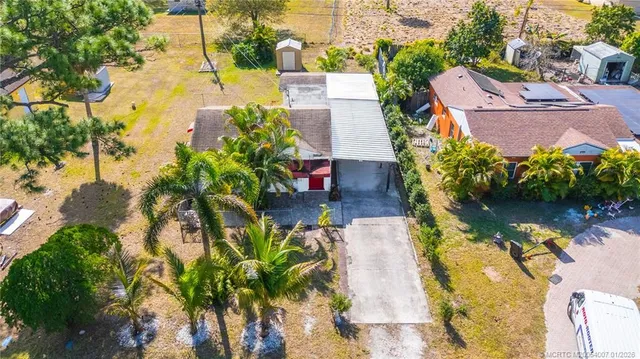 an aerial view of a house with a yard basket ball court and outdoor seating
