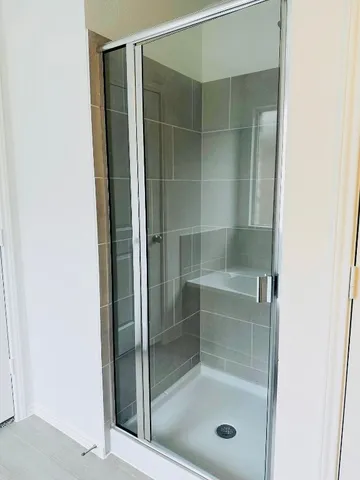 a bathroom with a glass shower door
