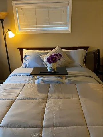 a bedroom with a bed and window