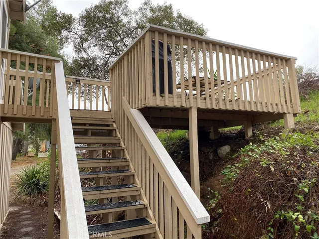 a view of balcony with wooden floor and fence