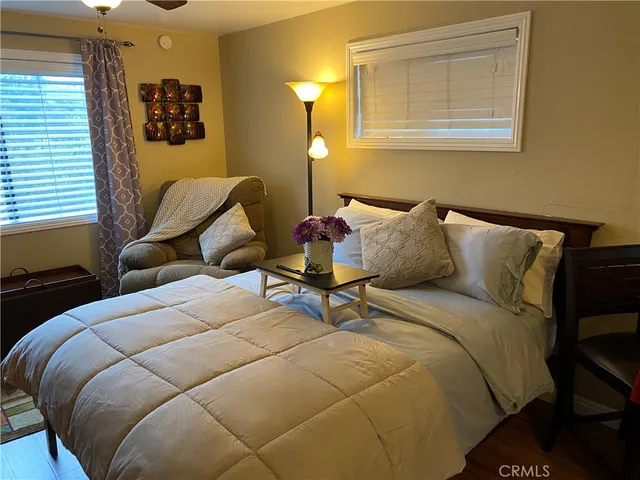 a bedroom with bed and window