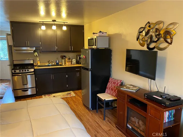 a kitchen with granite countertop a stove and a refrigerator