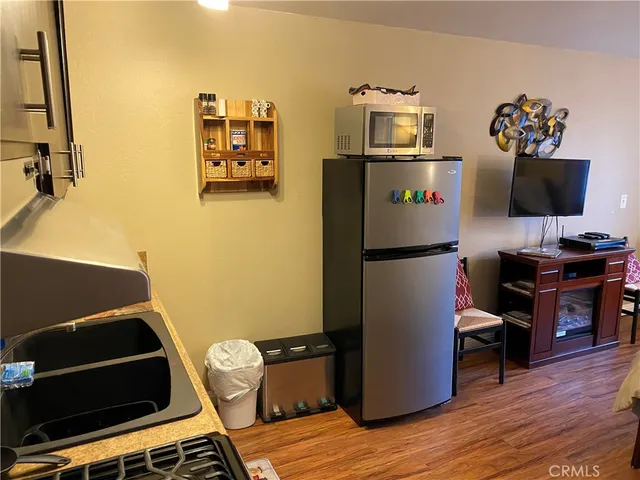 a kitchen with stainless steel appliances granite countertop a refrigerator and a stove top oven