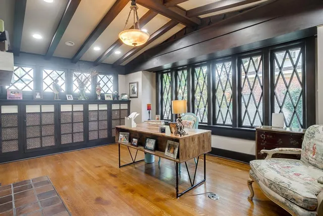 a living room with furniture a chandelier and a large window