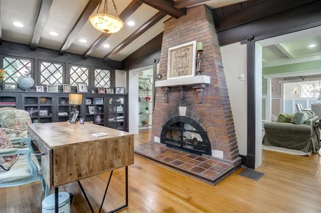 a living room with furniture a fireplace and a table