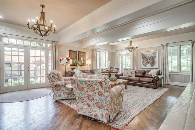 a living room with fireplace furniture and a chandelier