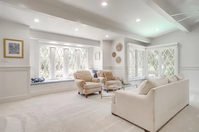 a living room with furniture and large windows
