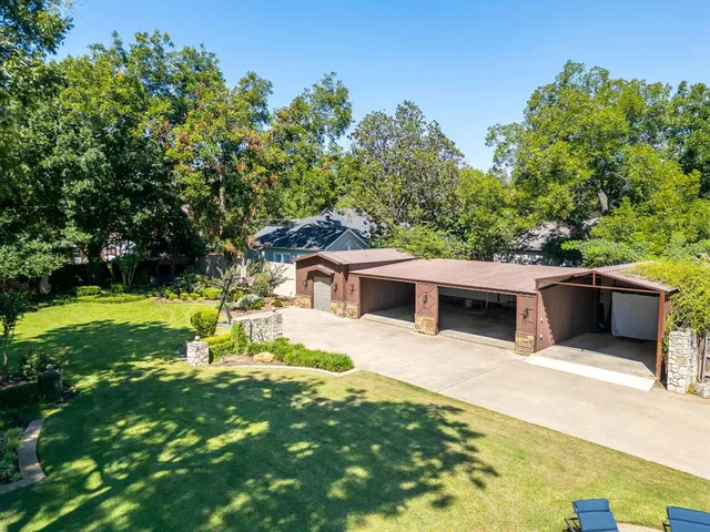 a view of a backyard with table and chairs and potted plants