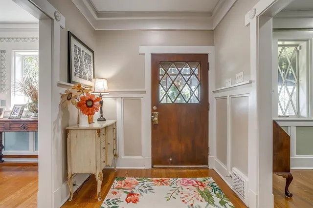 a view of hallway with furniture and a window