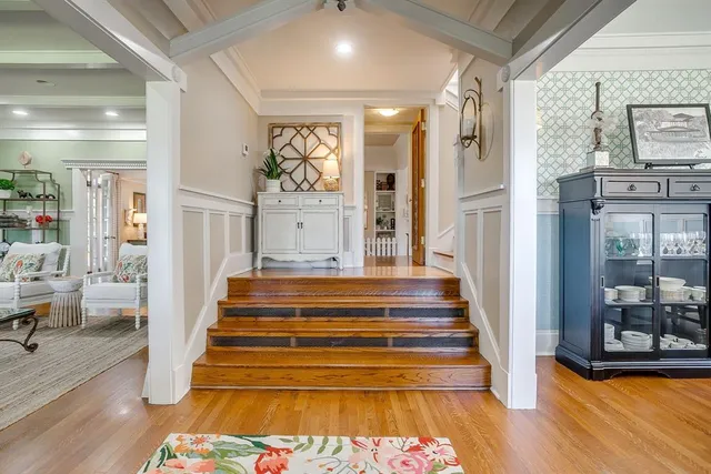 a view of entryway and hall with wooden floor