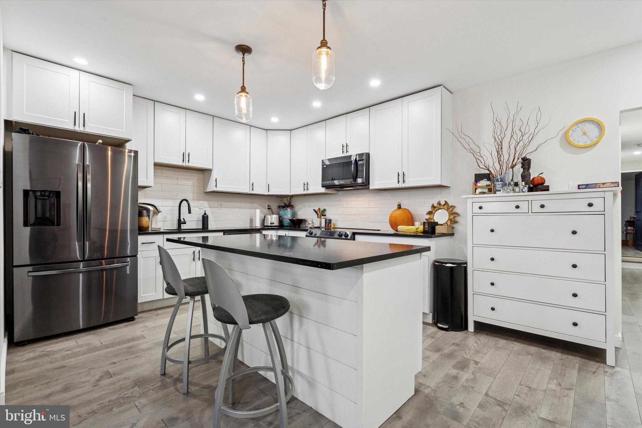 2694 Bridge Street Philadelphia, PA 19137 - Photo 28 of 41 a kitchen with stainless steel appliances granite countertop a sink stove a refrigerator and a refrigerator with wooden floor