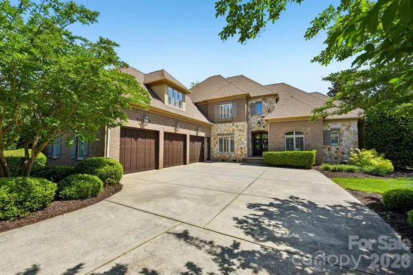a view of a house with a yard patio and fire pit