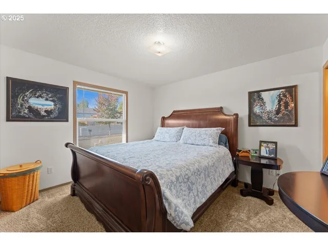 a bedroom with a bed and a desk