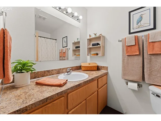 a bathroom with a granite countertop sink and a mirror