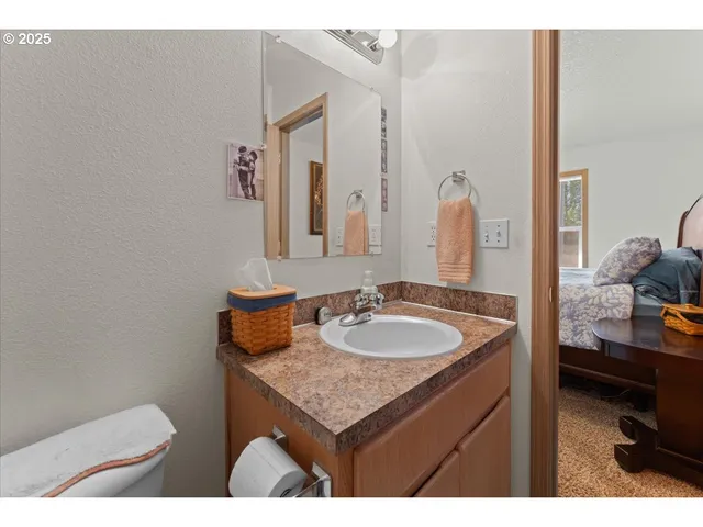 a bathroom with a granite countertop sink and a mirror
